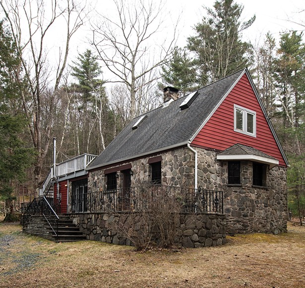 The handbuilt home was once part of an enclave of Norwegian immigrants and retains many of the original architectural details of rich wood, iron trim, and bluestone. Stewart covered the back porch and added screens. - PHOTO: DEBORAH DEGRAFFENREID