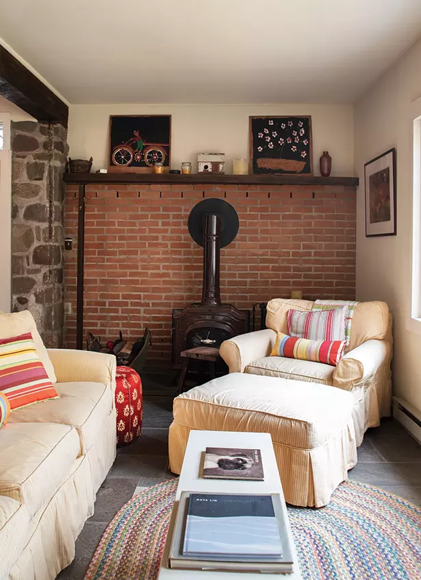 Former owners added a wood stove to the - downstairs “great room.” Stewart has surrounded the space with cozy chairs to create a nook for reading or guests. Since buying the house, she’s had many friends - move to the area, and befriended many locals. - PHOTO: DEBORAH DEGRAFFENREID