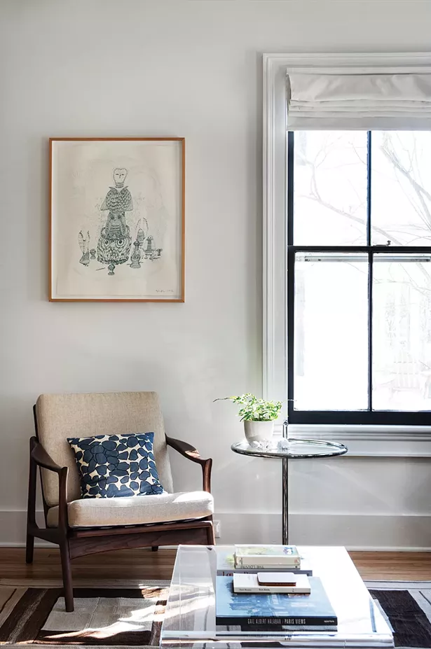 A corner nook of Walker’s downstairs living room was created by closing up an extra kitchen door. The sketch above the chair is a limited-edition print Walker bought in Brooklyn. One particular task she loves is - helping clients hang art. “I think it’s something I’m very skilled at. People often don’t know how to hang work or the right space to hang it. Sometimes beautiful pieces - are hidden away somewhere,” she says. - PHOTO: DEBORAH DEGRAFFENREID