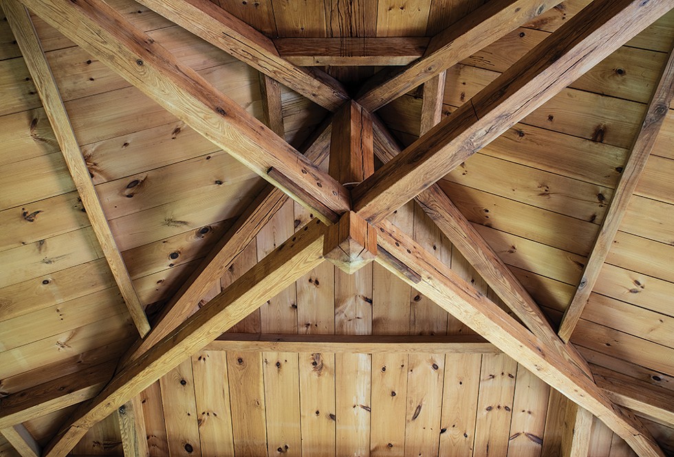 The home’s main room has a vaulted ceiling and a cupola. After clearing the land, Duncan milled the beams himself from the property’s abundant red oaks and used mortise-and-tenon joinery to frame the house. - PHOTO: DEBORAH DEGRAFFENREID