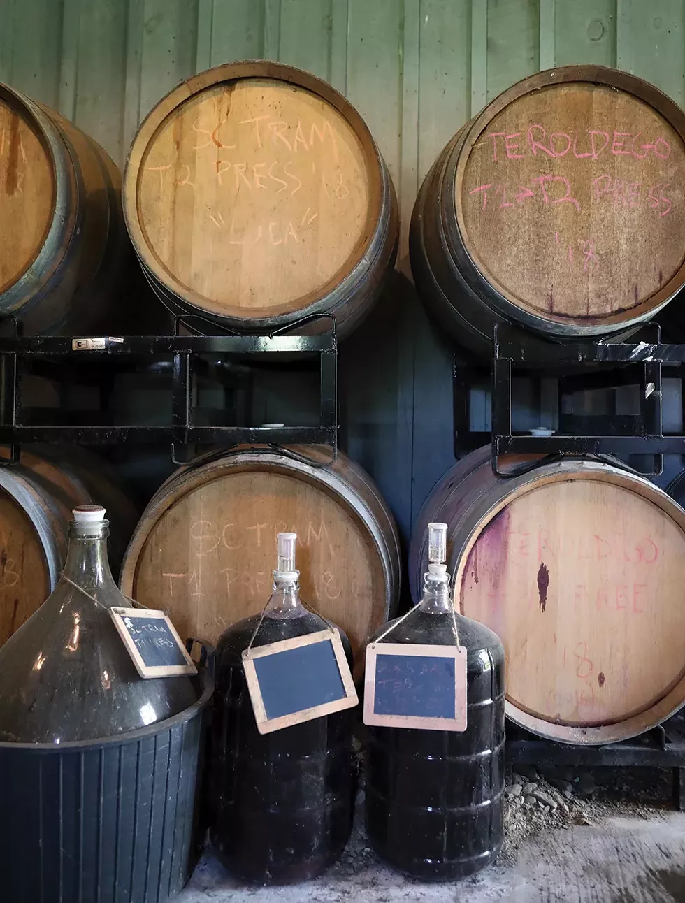 The glass demijohns on the floor hold wine used for topping up the barrels during fermentation and aging. - PHOTO: PETER BARRETT