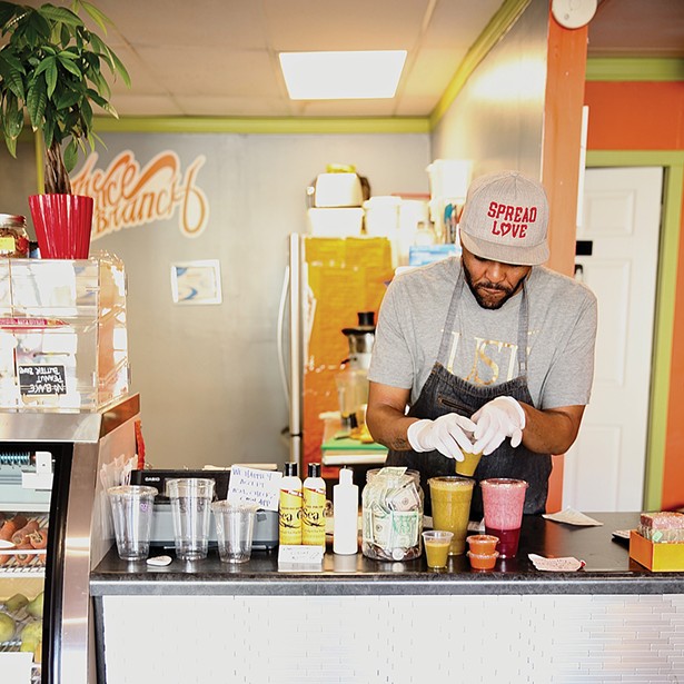 George Salter, co-owner of the Juice Branch - makes their signature juices for customers. - PHOTO: NIVA DORELL