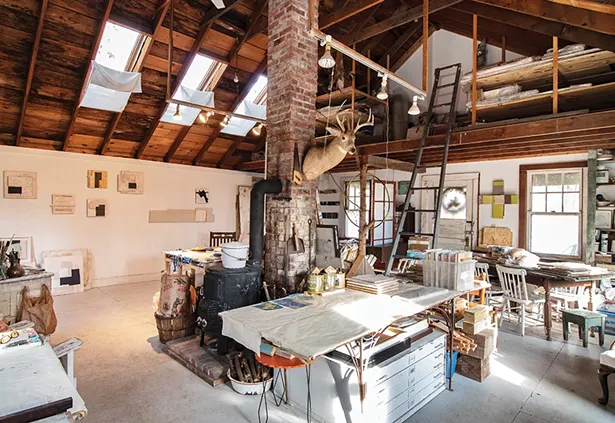 Jean Feinberg rescued a forsaken summer cottage near Lake Taghkanic and transformed it into her 400-square-foot, year-round art studio. Lining the walls, various iterations of her oil paintings explore an abstract motif inspired in part by her experience rejuvenating her property. “For years I’ve been playing with very intense, flat and uninflected color against either raw wood or found wood,” explains the former teacher. “I found my path to working this - way from the delight of having so many color chips around me as I was painting the house. Color can shift so much in intensity, value or hue, and each of these shifts influences feeling as well.” - PHOTO: DEBORAH DEGRAFFENREID