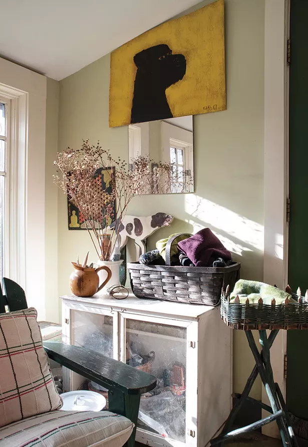 At the entrance of Feinberg’s apartment, she created a sunny landing and mudroom area by shifting the bathroom to an adjacent closet. Feinberg bought the bright yellow painting of a dog by outsider artist and local legend Earl - Swanigan on the street in Hudson. - PHOTO: DEBORAH DEGRAFFENREID