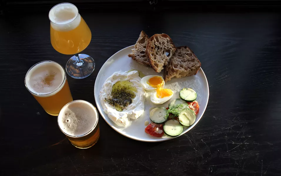 A selection of beers with the Atlantic Avenue breakfast: soft-boiled egg, labneh, roasted tomatoes, cucumbers, and levain toast. - ABBY FOSTER