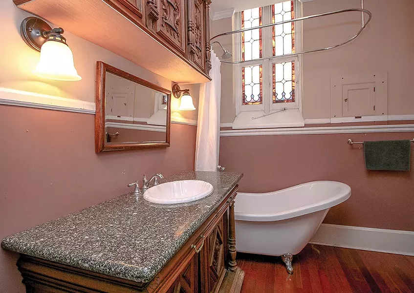 A freestanding slipper tub sits in a corner of the bathroom under a stained glass window. “I just loved the slipper tub,” says Bokaer. “As a choreographer, I know how important it is - to take care of the body.” - PHOTO BY SETH DAVIS