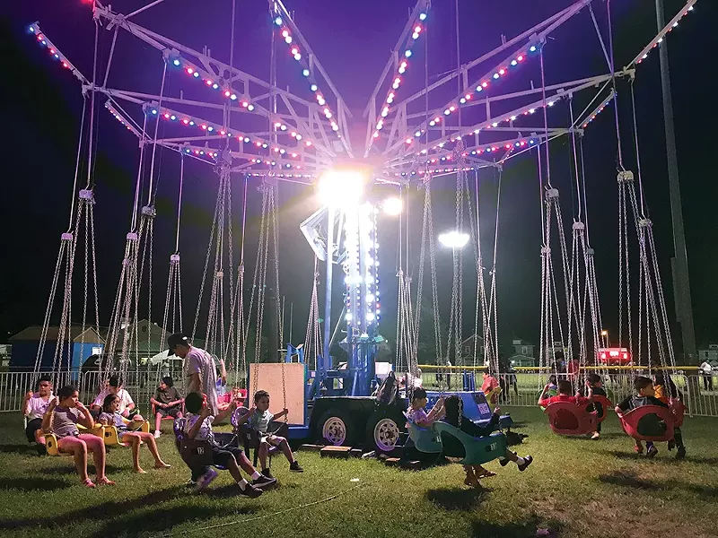 Children enjoying the swing carrousel at Delano Hitch Park. - PHOTO BY STEPHANIE QUISPE