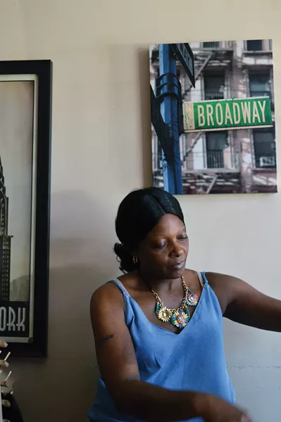 Strong Women of Newburgh 2018 series: Sha is preparing before a days work at her salon on lower Broadway. - PHOTO BY THERESE FISCHER