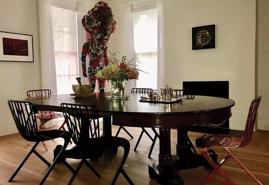 A Nick Cave Soundsuit lurks in the corner of the dining room, which also features a William Eggleston photo, a multimedia work by Matthew Day Jackson, and a fur-lined cup by Pruitt-Early on the table.