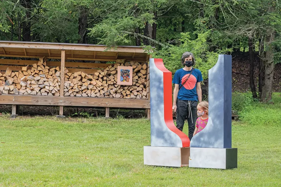 Visitors to Stoneleaf Retreat during Upstate Art Weekend - behind a sculpture by Leah Dixon. - PHOTO BY TRINICIA M PERCH.