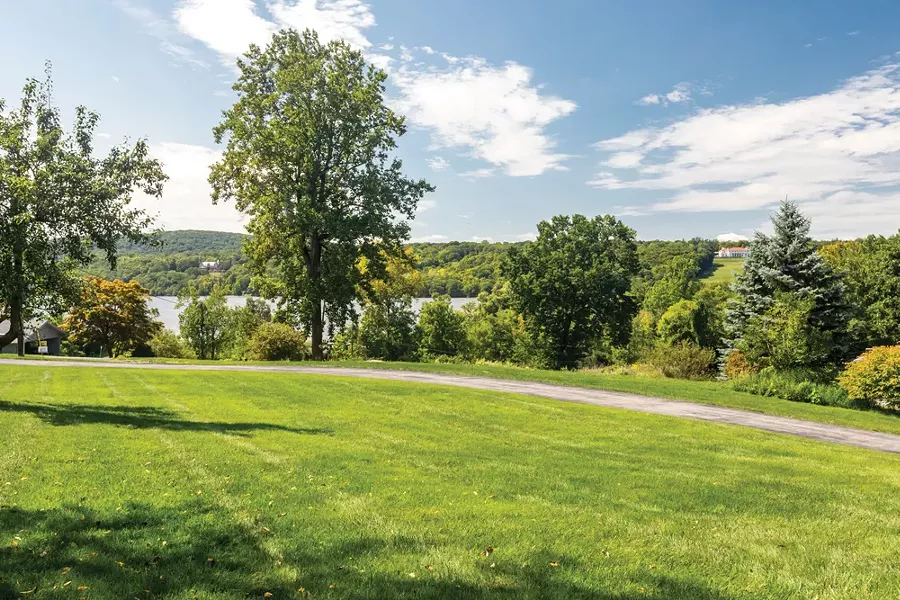 Set on a grassy hill in Hyde Park, Smyle and Schultz's Mid-Century Modern home enjoys sweeping views of the Hudson River. - PHOTO BY WINONA BARTON-BALLENTINE