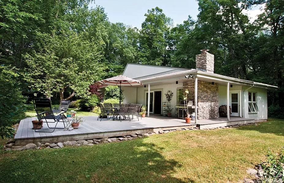 Abbe Aronson's midcentury modern house in the Riverby section of Woodstock. "We love our house all year, but it's especially great in the summer when we can be so indoor/outdoor," she says. - DEBORAH DEGRAFFENRIED