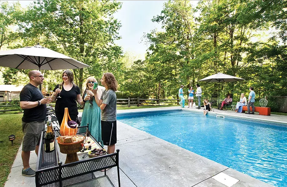 Abbe Aronson (in back) and friends by her saline pool. Both being outside in nature and being surrounded by a community that is so music and art centric are things she's grown to love since moving to Woodstock. - DEBORAH DEGRAFFENRIED