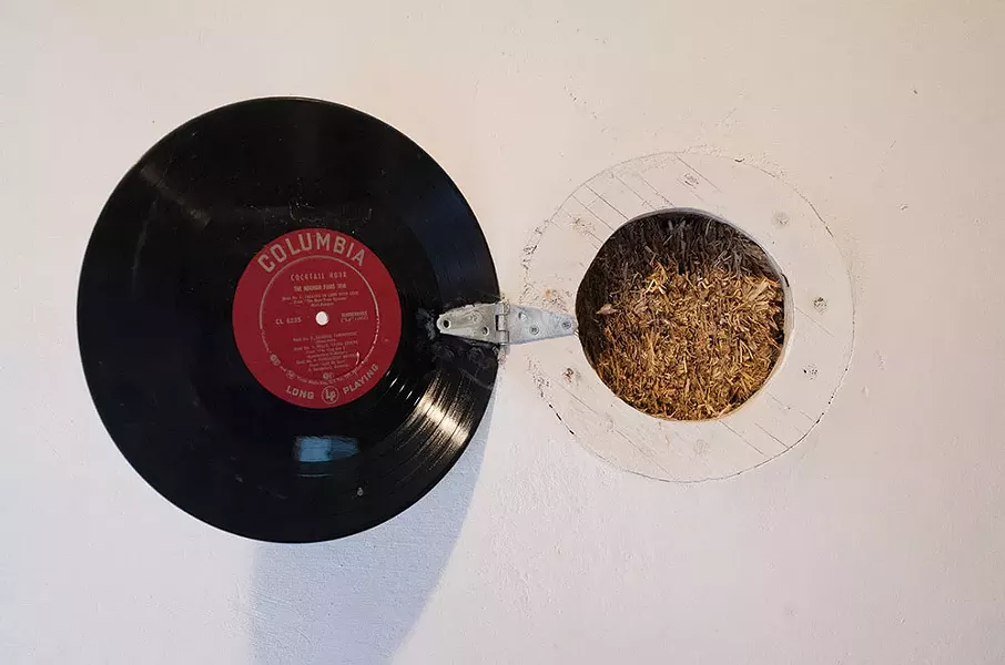 In a wall of Dean Jones's No Parking Studio in Rosendale, a porthole fashioned from an old LP opens to display the core of its straw-bale construction - FIONN REILLY