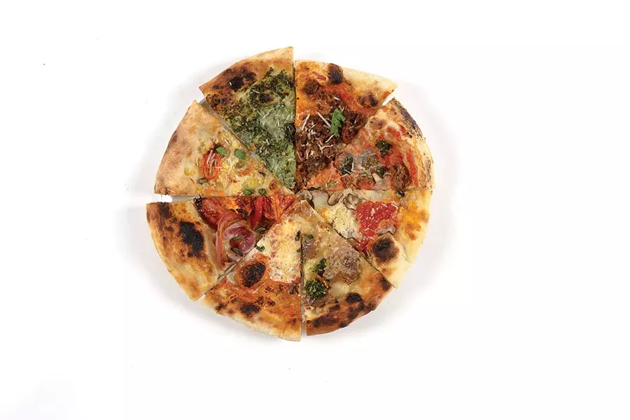 A variety of slices made from recipes in The Pizza Book. Clockwise: Corn + Scallion, Taco Pie, Kale + Sausage, Mushroom, Porchetta, Classic, and Panchetta + Slow Tomato - TOM EBERHARDT-SMITH