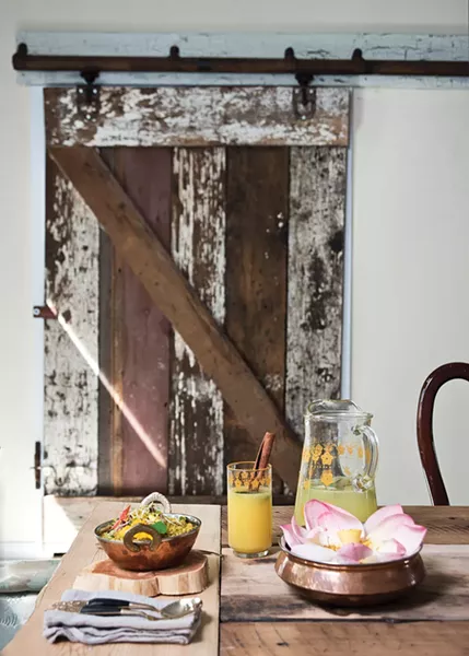 The dining room where Narine serves her "spice suppers." She transplanted doors from her Dutch barn to give the room a rustic flair. - DEBORAH DEGRAFFENREID