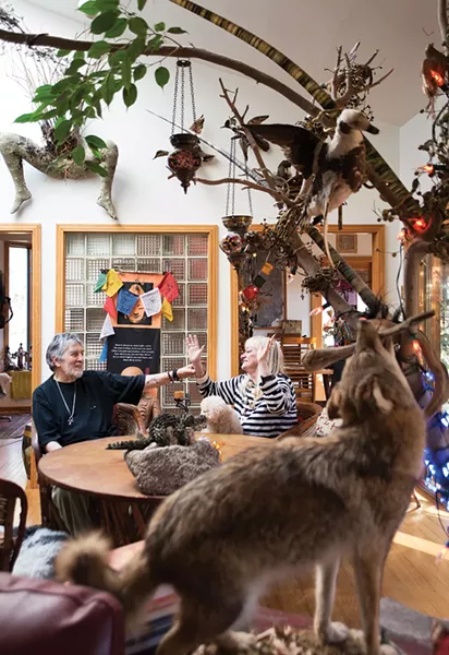 Ty Castellarian and Diane Termana sit at the center of their art-filled home. The ceramic Buddha once belonged to actor Lee Marvin. - DEBORAH DEGRAFFENREID