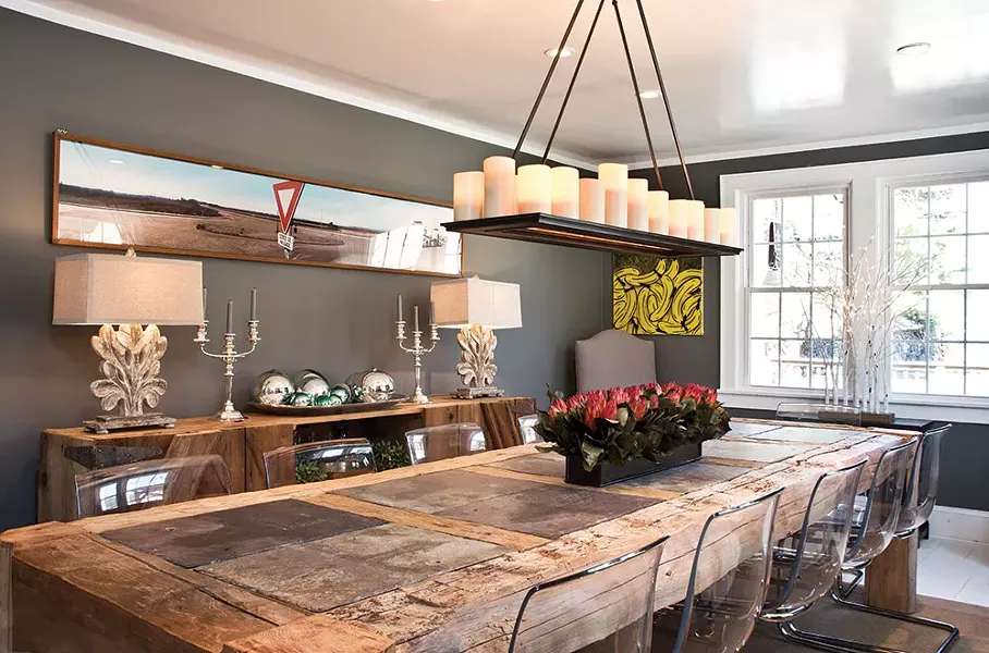 The Adams' dining room. Daniel Adams designed the family's wooden dining room table to include slate plate settings. Chalk is always on hand to mark seating arrangements or entertain children. - DEBORAH DEGRAFFENREID