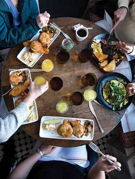 Sunday Brunch: Crispy Chicken Biscuit (housemade biscuit with crispy chicken, pimento cheese, bacon, and pickled fresno peppers), Sweet Potato & Goat Cheese Frittata(smoked onions, local greens), Steak and Eggs. - CHRISTINE ASHBURN