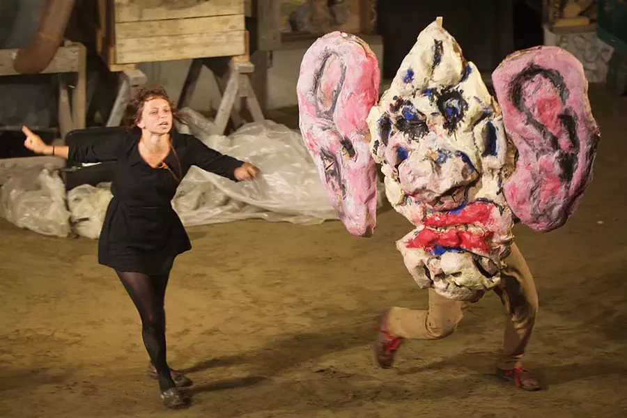 The narrator(Esteli Kitchen) explains the function of gargoyle (Tyson Houseman) in the Bread & Puppet production of "Faust 3," performed at Time and Space Limited in Hudson. - MARK DANNENHAUER