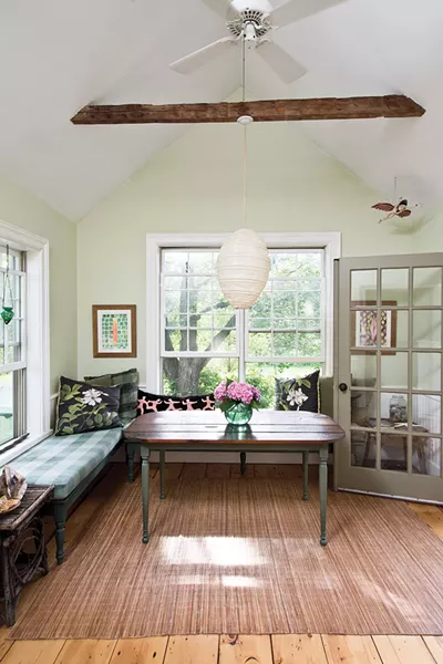 The dining area of Shaff’s home overlooking the backyard. “In the warmer weather we live between the house, the out building, and the iron bed under a shade tree,” she explains. - DEBORAH DEGRAFFENREID