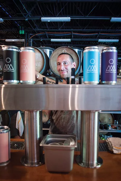 Grady Salter pouring brews. - PHOTO BY CHRISTINE ASHBURN