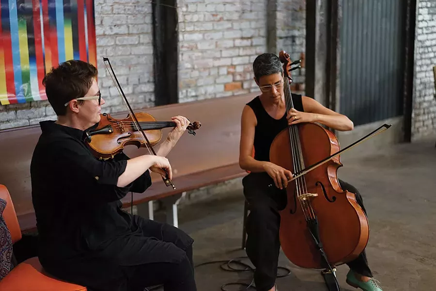 Darcy Doniger and Carolyn Mix, 2 Note apothecary shop owners, perform during the social hour. - JOHN GARAY