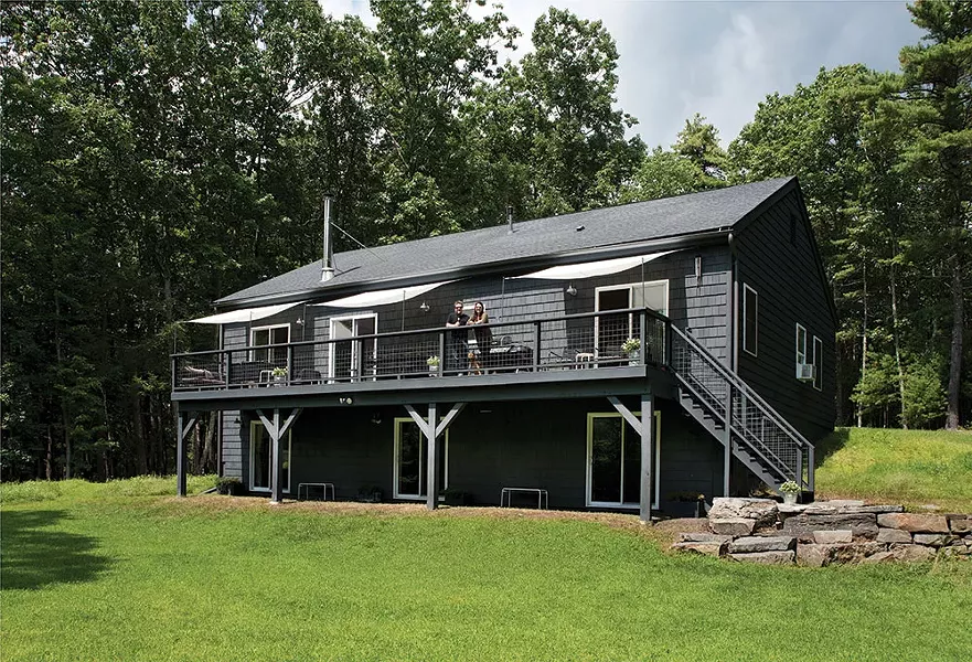Kate Cummings and Griffin Stenger on the deck of their New Dutch Vernacular home. Their 12-acre property is bordered by a pond on one side and the beginnings of the Kripplebush Creek on the other. - DEBORAH DEGRAFFENREID