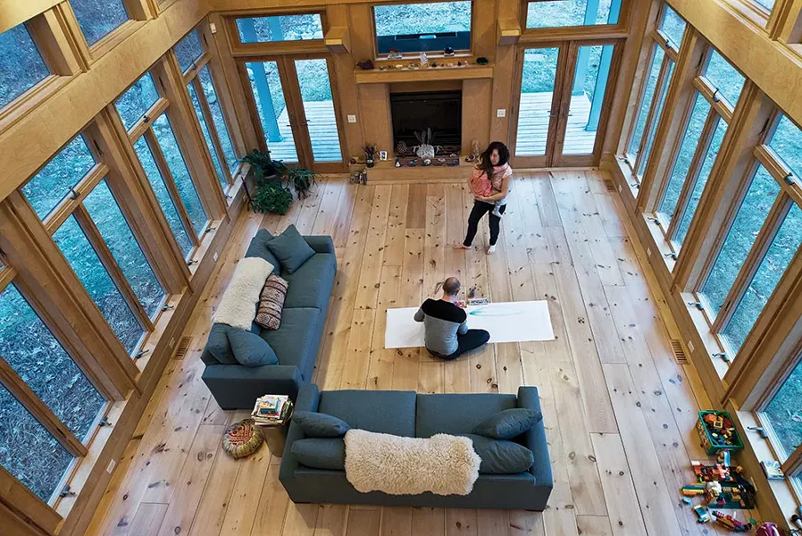 The home’s two-story main room is open to the upstairs loft. The bare floors are intentional. “We are a dancing family,” explains Diamond. “We dance every day or we are in here making art.” - DEBORAH DEGRAFFENREID