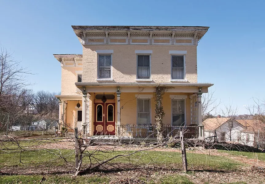 Khorramian’s home dates from 1840 and features many classic Italianate architectural details. A flat roof with a wide overhang is supported with curved cornices and an ornate border. The yellow brick facade and teal trim is also original to the structure. - DEBORAH DEGRAFFENREID