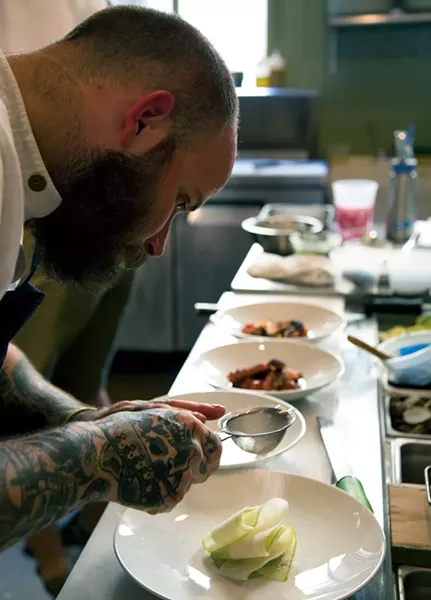 Chef Chris Turgeon plating an apple salad with German-engineering-level precision. - PETER BARRETT