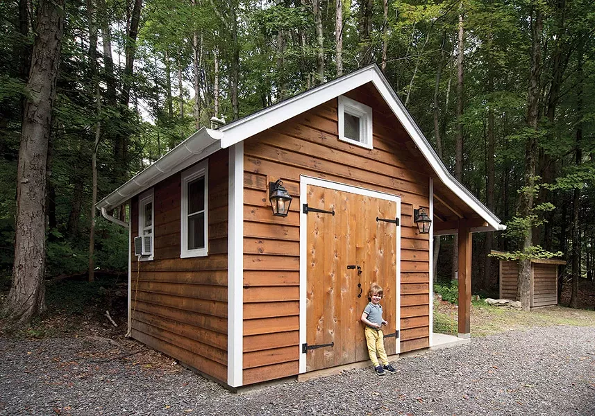 Hudson in front of the shed Bollman built. “Support systems are so important,” explains Bollman. “This is not just my story but the story of how all these pieces came together—it’s a really great neighborhood.” - DEBORAH DEGRAFFENREID
