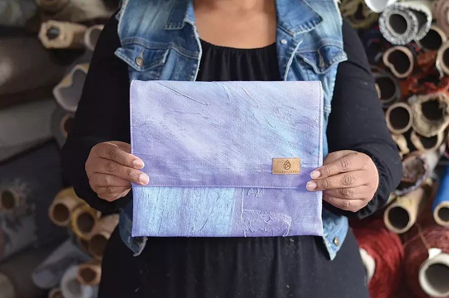 A handbag made from a backdrop from a Broadway show.