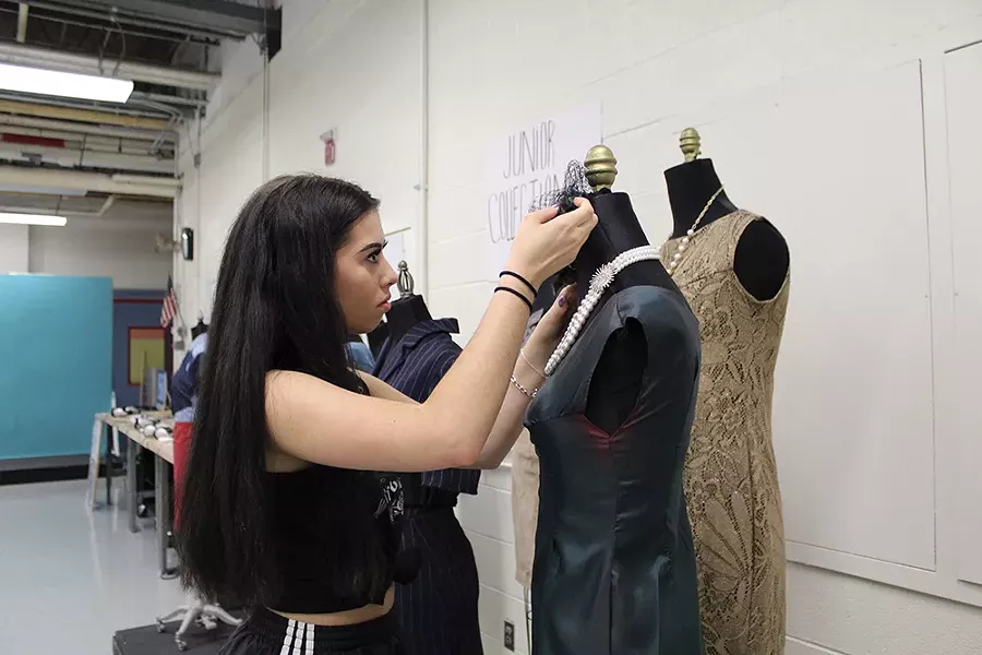 Deena McGarvey from New Paltz High School puts the finishing touches on her dress at the Ulster BOCES 2019 Fashion Design class’s end-of-year gallery exhibit.