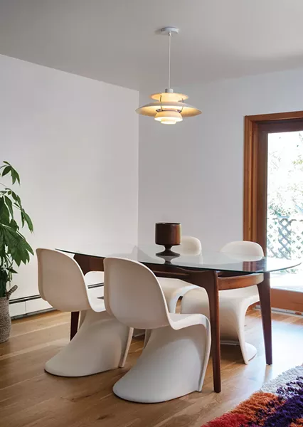 The dining room features a glass dining table designed by furniture designer-turned-shipbuilder Adrian Pearsall, Verner Panton single-injection plastic chairs, and a Louis Polson PH-5 pendant lamp. “We love the personalities of the designers from that era and the stories about their projects and artistic endeavors. They were all renaissance people,” says Davis. - PHOTO: DEBORAH DEGRAFFENREID
