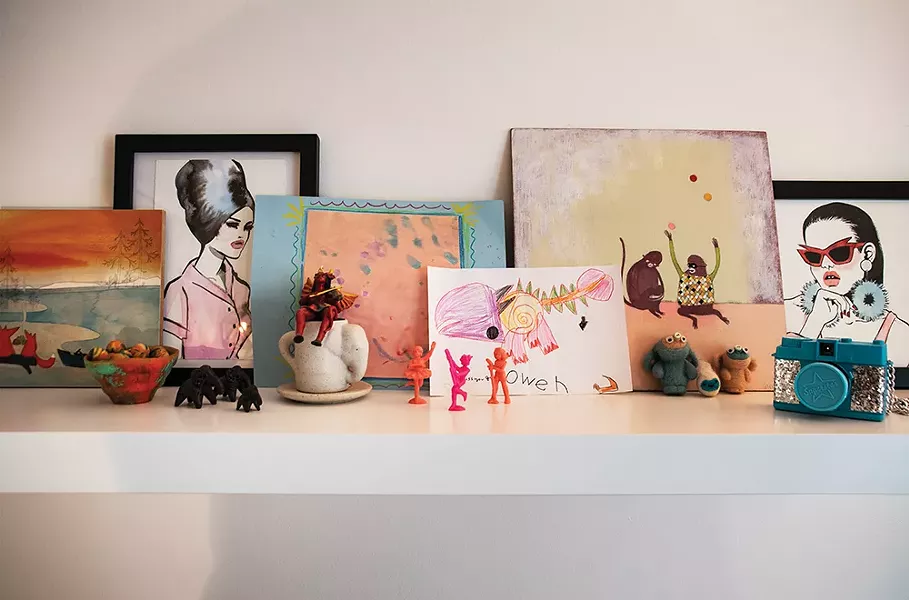 A shelf in Davis’s home office. She works in the - advertising industry in Manhattan. “I’ve always loved art and making things, but I’m not a painter or illustrator,” she says. “Working in design allows me to bring together different styles of illustration and photography then add typography to communicate a message.” - PHOTO: DEBORAH DEGRAFFENREID