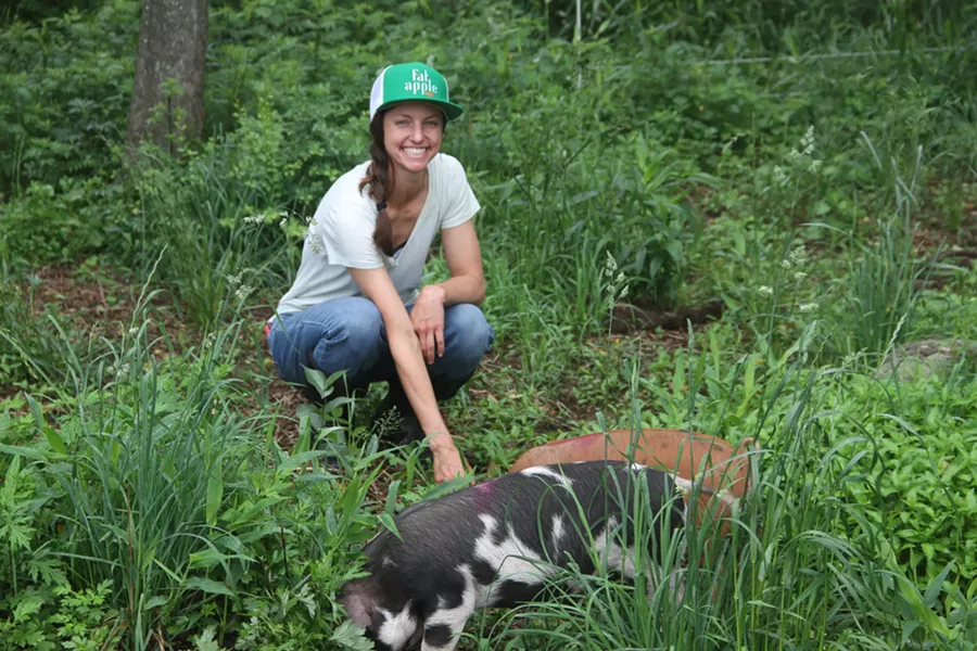 Second-Year Livestock Apprentice Emily Lupico tends to Glynwood's pigs.