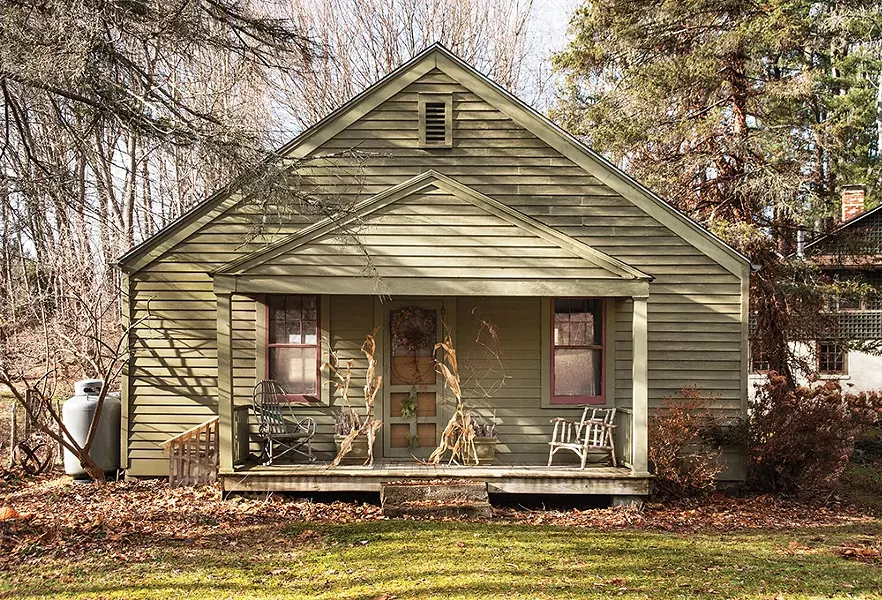 The front porch of the property’s original structure, once a summer cottage, looks across the road to preserved wetlands. “The amount of - time I’ve been up here has just flown by,” Feinberg says. “When I think about it, I’ve really accomplished a lot up here.” - PHOTO: DEBORAH DEGRAFFENREID