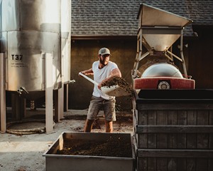 Matt Spaccarelli, winemaker and vineyard manager of both Benmarl and Fjord Vineyards, cleaning out the wine press at Fjord.