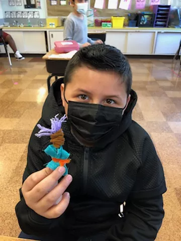 Kingston student with worry doll. - REHER CENTER