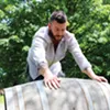 Todd Cavallo rolls a barrel into the yard to use as a tasting table. Todd Cavallo rolls a barrel into the yard to use as a tasting table.