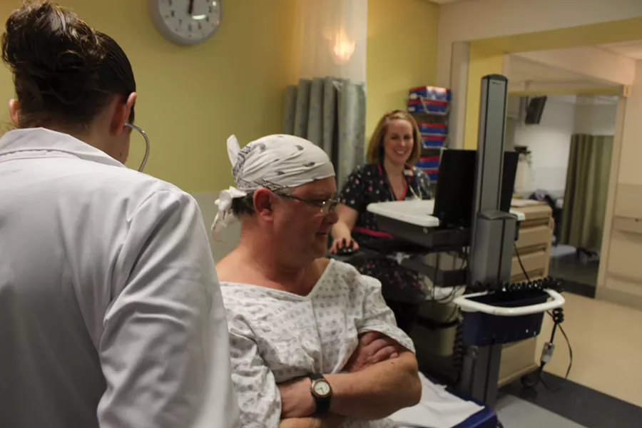 Vassar Brothers Medical Center RN Sarah Ogasian enters updates on an emergency room patient into the hospital’s new electronic medical record system.