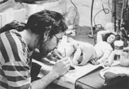 A grubby John Cusack, playin' with puppets.