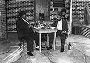 Charles Robinson, Saundra Holmes, and Butch Terry, chewing the fat.