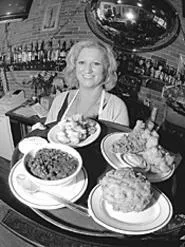Clockwise from right rear: Catfish platter, fried - macaroni and cheese, red beans and rice, fried - pickles, and Susie "Slingo" Porter, home-cookin' - mama. - WALTER NOVAK