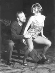 Dermatologist Larry (Terry Burgler) inspects the skin - of Alice (Jodi Dominick).