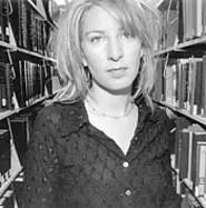 Dore amid the books -- just like Lucinda Williams might do.
