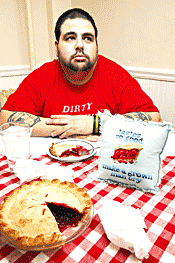 Greg Der Ananian contemplates a cherry pie and a naughty - pillow.