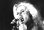 Hedwig emotes for the Menses Fair throng.