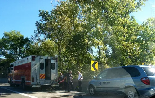 Investigators gather along the I-90 ramp to the Inner Belt, just outside the crime scene